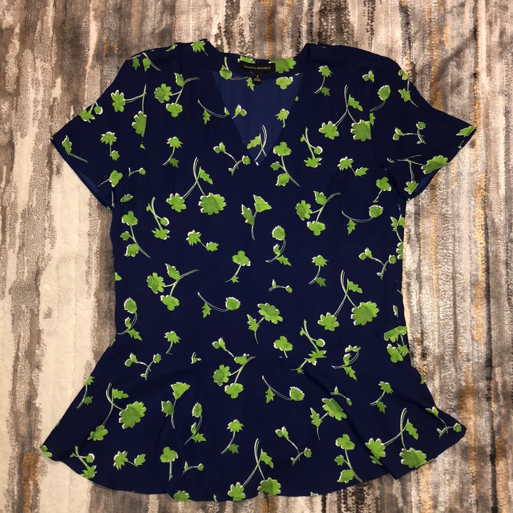 Leafy greens on a navy blue dressy blouse top